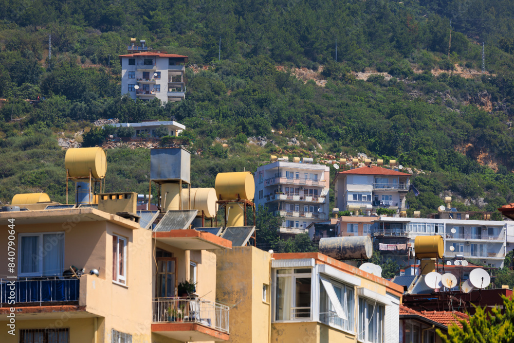 Fototapeta premium Southern cityscape, view of buildings and houses with green plants in public places in Turkey, sunny summer day in the city of Istanbul