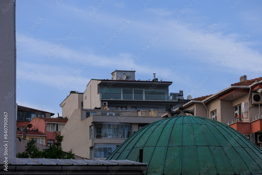 Fototapeta premium Southern cityscape, view of buildings and houses with green plants in public places in Turkey, sunny summer day in the city of Istanbul