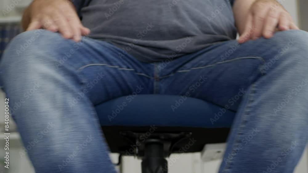 Blurred Shooting with a Person Rotating Around with an Office Chair in the Office. Businessman Sitting on a Chair in the Office.