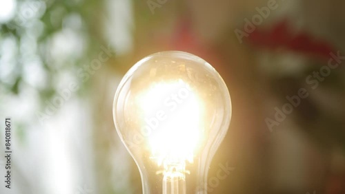 One Person Screws a Led Light Bulb in the Socket and Turn On the Light in the Room. Saving Energy Concept Using Led Bulb.