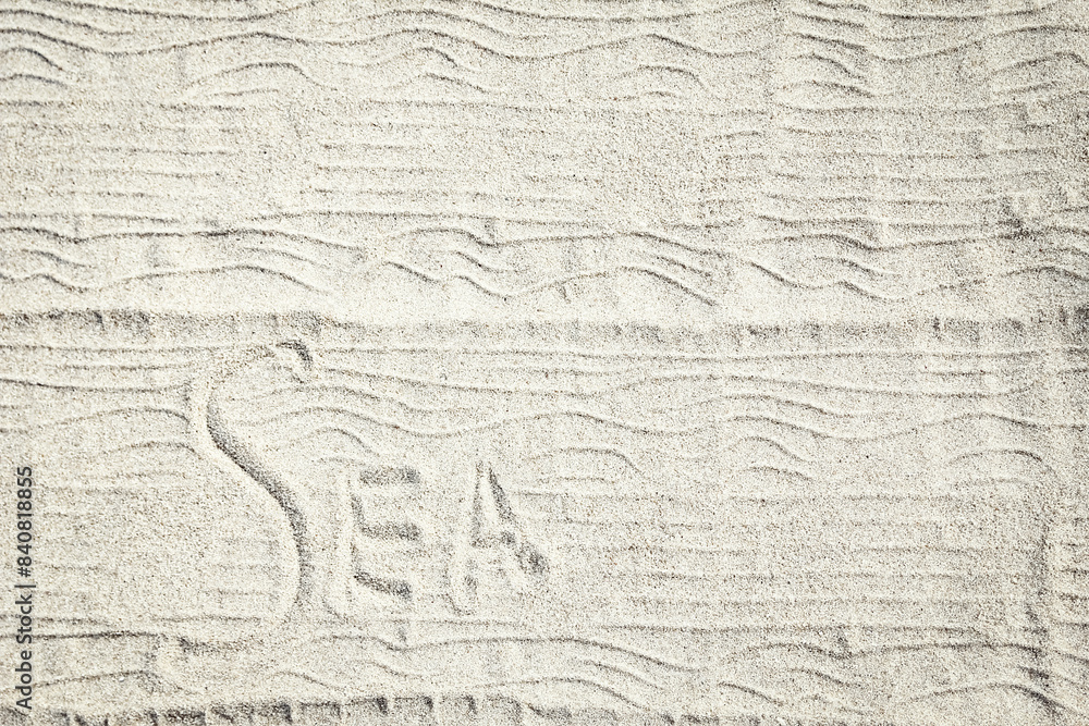 Obraz premium A drawing on the sand by the sea travel background