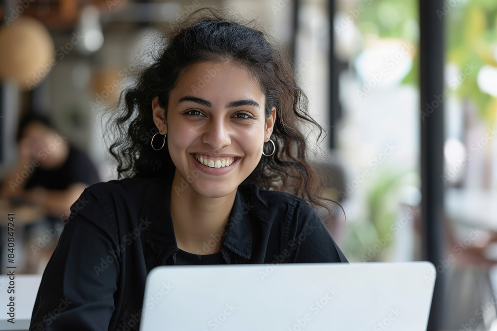 Happy Young Female Student Studying on Laptop in a Bright Cafe Happy Young Female Student Studying on Laptop in a Bright Cafe