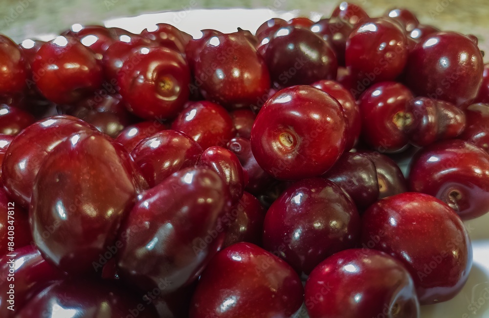 the first harvest of dark red cherry fruits grown in the gardens of the South of Russia, close-up the first harvest of dark red cherry fruits grown in the gardens of the South of Russia, close-up
