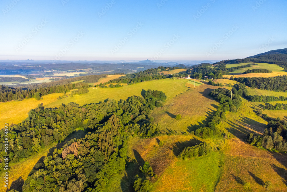 Fototapeta premium Green hilly landscape with green meadows and forests. Jested ridge near Liberec, Czechia. Aerial view from drone.