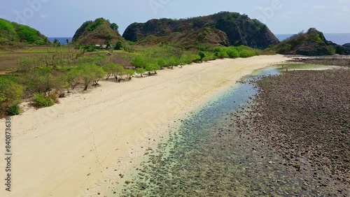 Low flying view of a remote, empty tropical beach and blue ocean photo