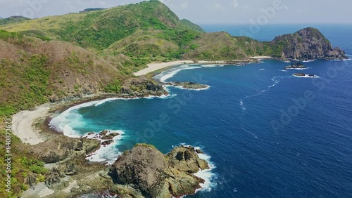 Aerial view of a blue tropical ocean and jagged cliffs photo