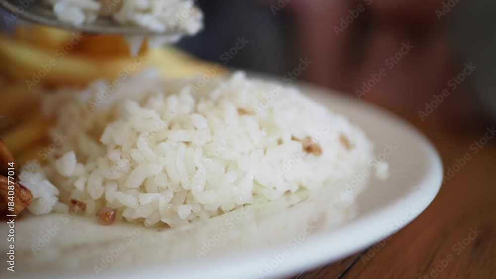 Closeup of a plate featuring white rice, French fries, and a fork, creating a delicious meal Closeup of a plate featuring white rice, French fries, and a fork, creating a delicious meal