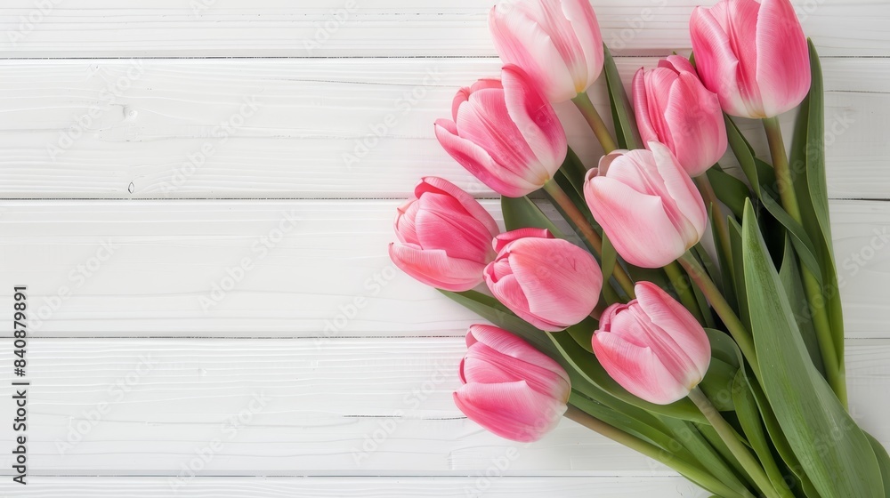 Pink tulips bouquet on white table with copy space, top view flat lay for elegant display Pink tulips bouquet on white table with copy space, top view flat lay for elegant display