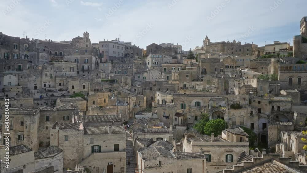 A stunning view of the ancient, architectural town of matera in basilicata, italy showcasing its historic stone buildings and tight-knit community dwellings. A stunning view of the ancient, architectural town of matera in basilicata, italy showcasing its historic stone buildings and tight-knit community dwellings.