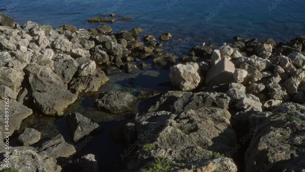 Rocky coastline at gallipoli, puglia, italy, europe, showcasing a natural seascape with boulders and clear blue water in an outdoor setting.