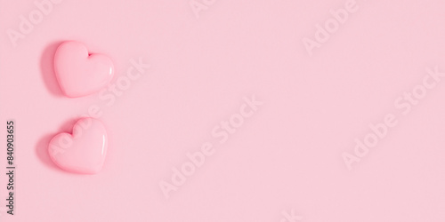 Two pink smooth hearts on pastel pink table background. Birthday, Wedding, Mother's Day, Valentine's day, Women's Day. Flat lay, top view, copy space