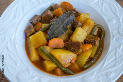 Estofado de carne con patatas, zanahorias y habichuelas photo