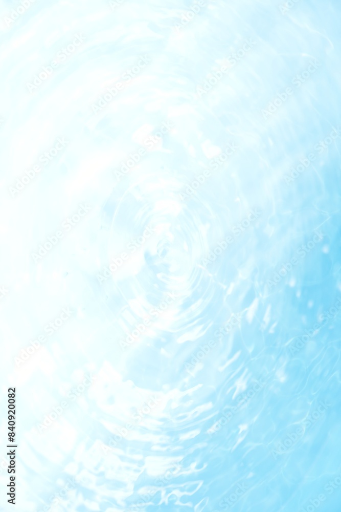 Obraz premium Blue water with ripples on the surface. Defocus blurred transparent blue colored clear calm water surface texture with splashes and bubbles. Water waves with shining pattern texture background. 