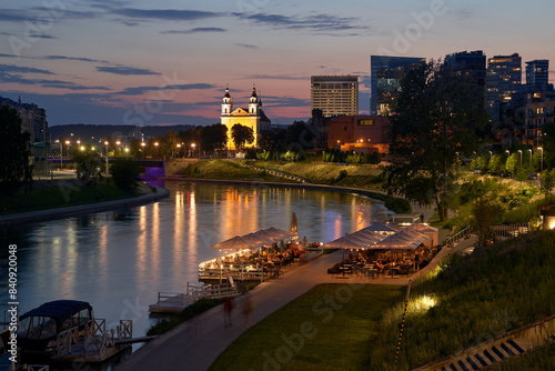 Obraz na płótnie Vilnius night sunset panoramic cityscape with Neris river, boats, cafe, church and skyscrapers of New Center. Lithuania, Baltic states. w salonie