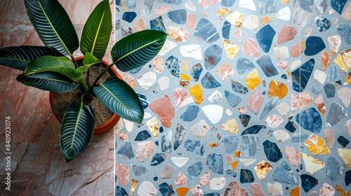 A terrazzo surface showcasing vibrant chips and patterns with a potted plant on top photo