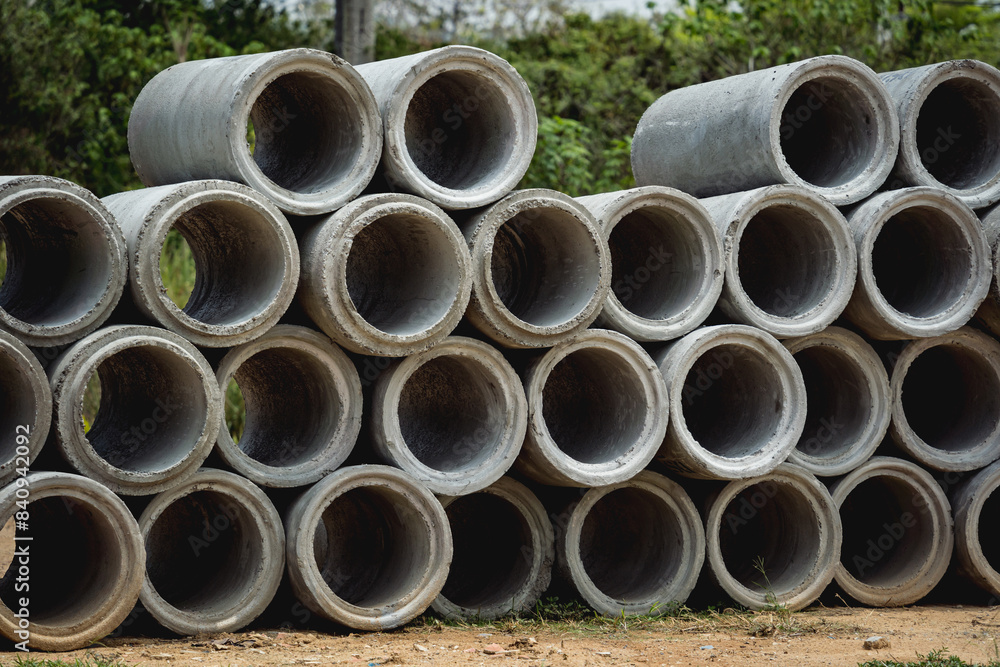 A stack of concrete ring pipes piled and creating a symmetrical arrangement A stack of concrete ring pipes piled and creating a symmetrical arrangement