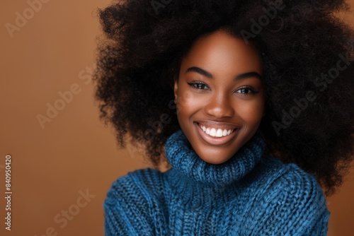 A smiling black woman stares at the camera. © Avve Diana
