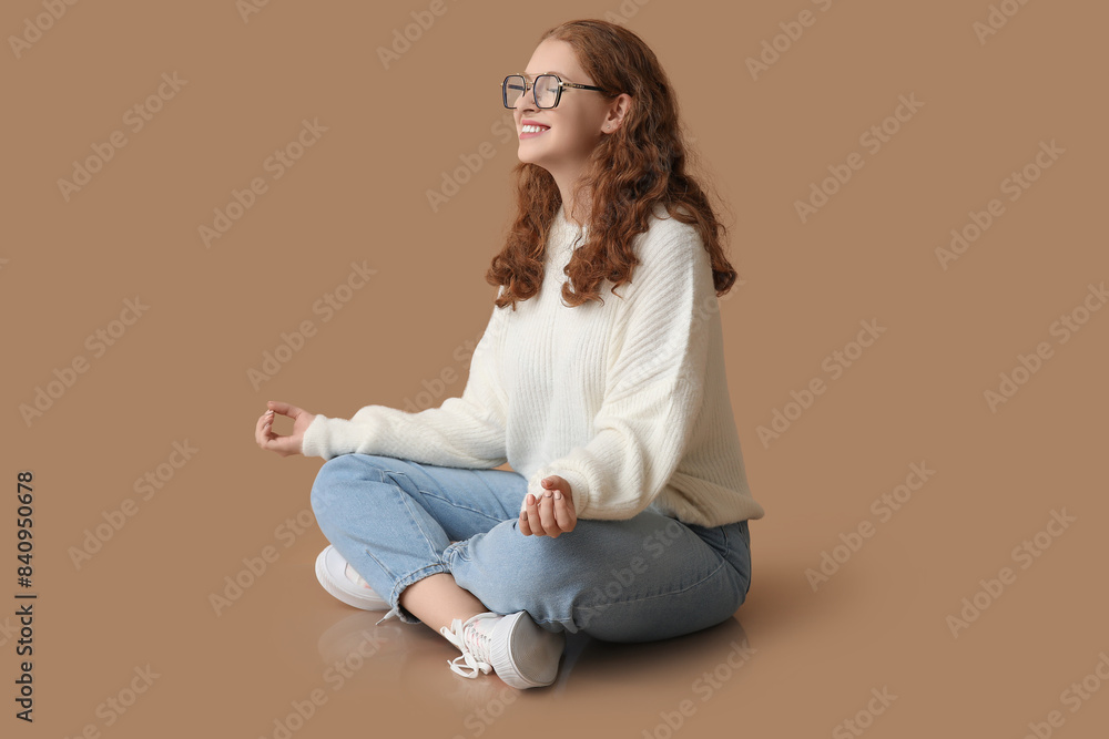 Portrait of relaxed young woman meditating on brown background Portrait of relaxed young woman meditating on brown background