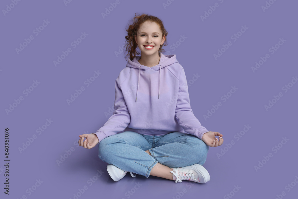 Portrait of relaxed young woman meditating on purple background Portrait of relaxed young woman meditating on purple background