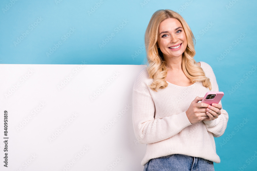 Photo of cheerful lovely woman wear trendy white clothes introduce empty space isolated on blue color background Photo of cheerful lovely woman wear trendy white clothes introduce empty space isolated on blue color background