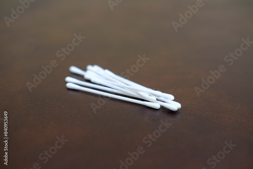 Cotton bud wood stick or cotton swab cotton wool on brown background, healthcare, stock photo. photo