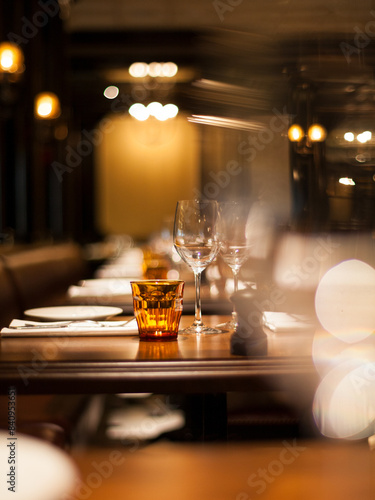 Table setting at a fancy restaurant with moody lighting.