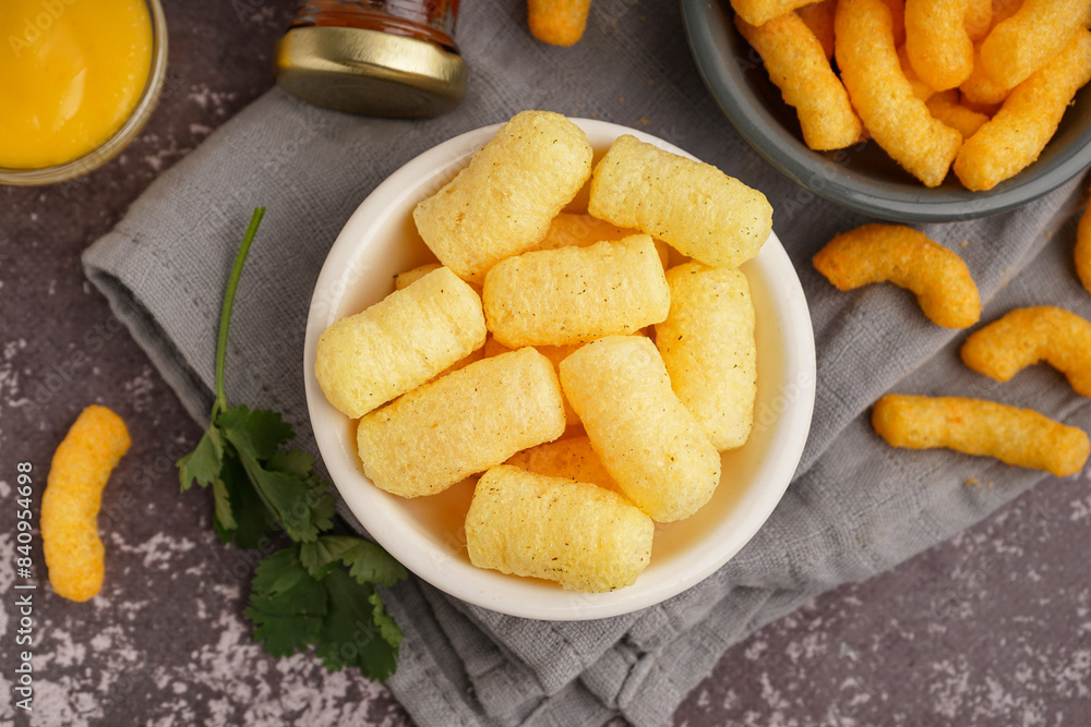 Bowls with tasty salty corn sticks and sauce on grunge background, closeup Bowls with tasty salty corn sticks and sauce on grunge background, closeup