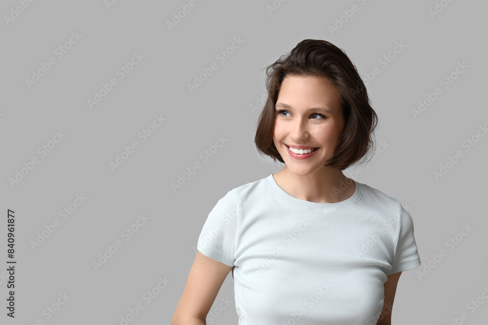 Beautiful young happy woman with bob hairstyle on grey background Beautiful young happy woman with bob hairstyle on grey background