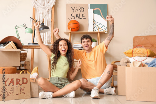 Happy young couple sitting ...