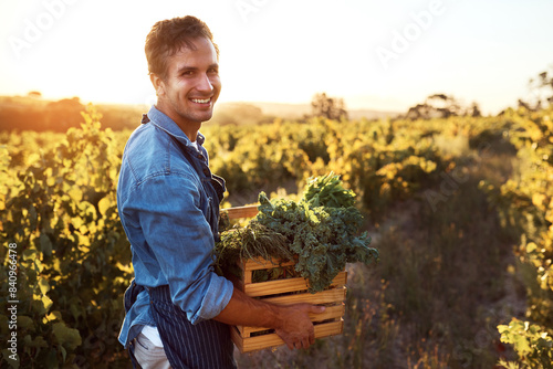 Portrait, sunshine and man with plants, vegetables and agriculture with crops, harvest and sustainability. Organic produce, face and guy with fresh food, summer and nature with nutrition or farming
