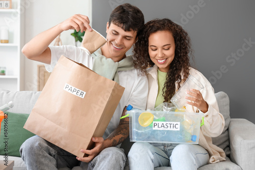 Young couple sorting rubbis...