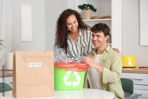 Young couple throwing plast...