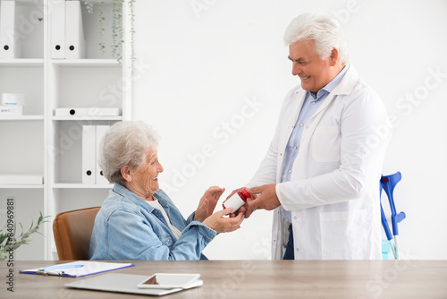 Senior woman taking pill bo...