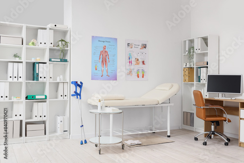 Interior of medical office with massage therapist's workplace and couch © Pixel-Shot