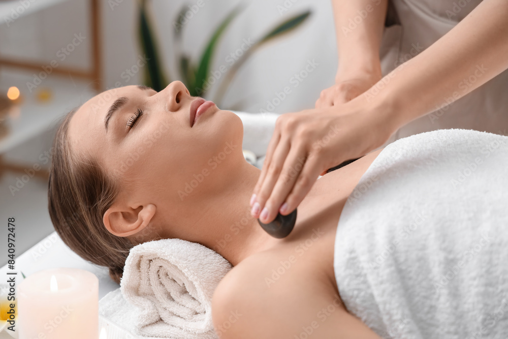 Young woman getting massage with stones in spa salon, closeup Young woman getting massage with stones in spa salon, closeup
