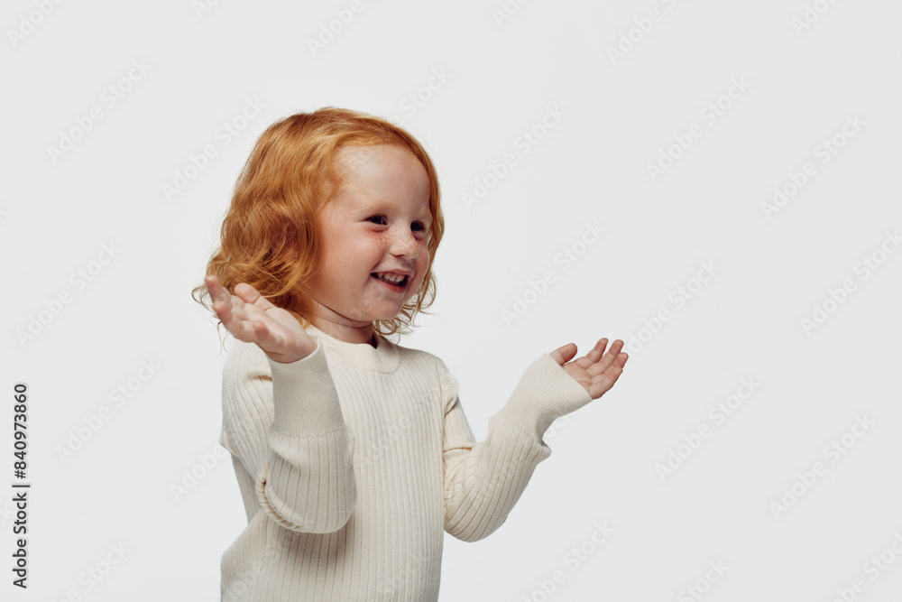 Happy redhaired girl with hands in the air against white background in a joyful moment of freedom Happy redhaired girl with hands in the air against white background in a joyful moment of freedom