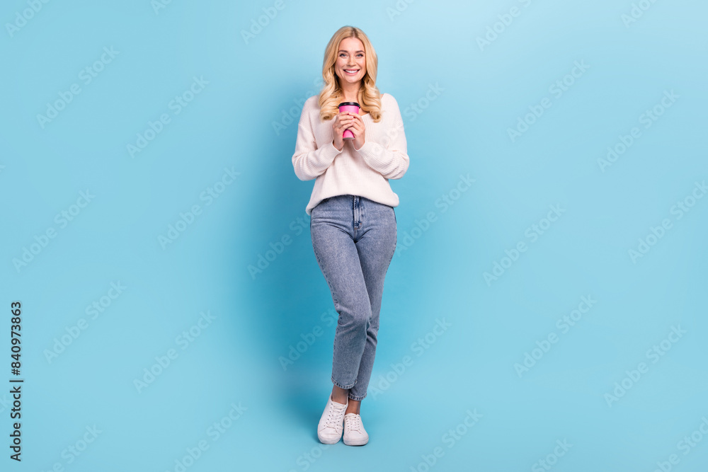 Photo of cheerful charming woman wear stylish white clothes drink tasty coffee isolated on blue color background Photo of cheerful charming woman wear stylish white clothes drink tasty coffee isolated on blue color background