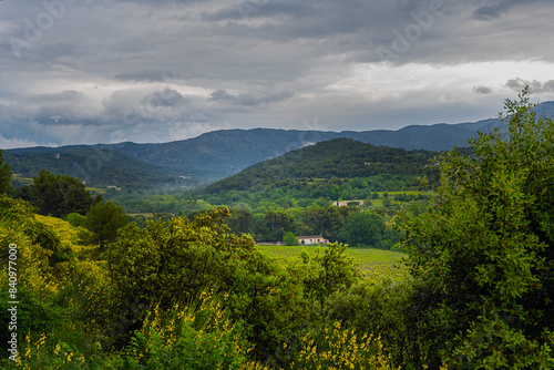 2024-04-14 VIEW OF A LUSH VALLEY WITH A MOUNTAIN RANGE IN THE DISTANCE IN THE PROVENCE REGION OF FRANCE NEAR BEDOIN photo