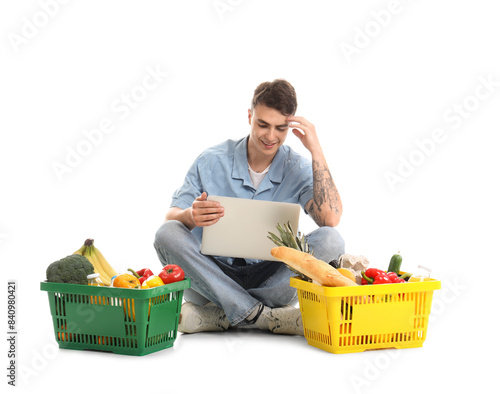 Young man with laptop and f...