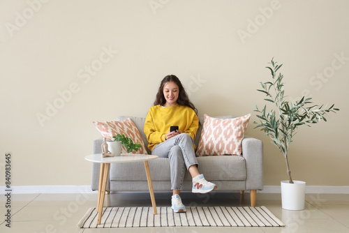 Young Asian woman using mob...