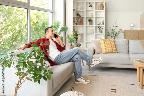 Young man talking by mobile...