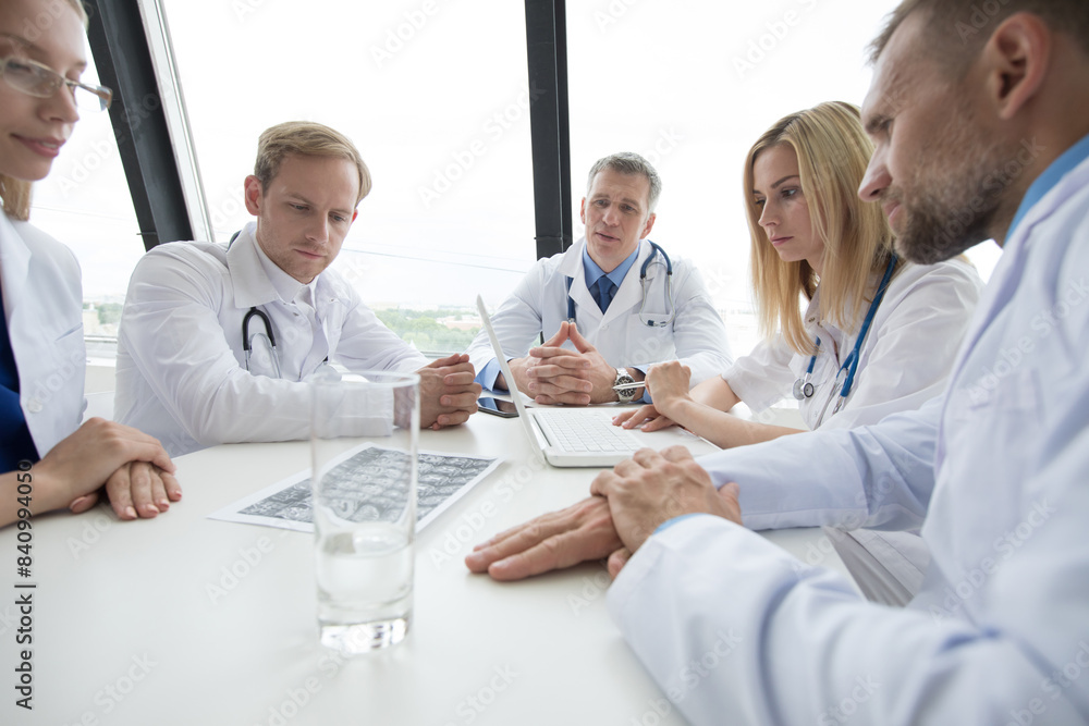Doctors meeting at a large white table Doctors meeting at a large white table