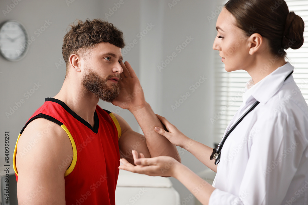 Sports injury. Doctor consulting patient in hospital Sports injury. Doctor consulting patient in hospital