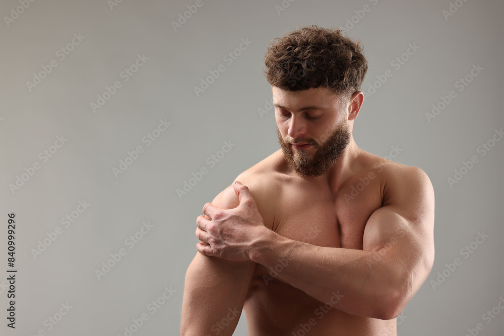 Handsome man with muscular body on light grey background. Space for text Handsome man with muscular body on light grey background. Space for text