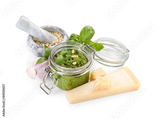 Fresh tasty pesto sauce and ingredients isolated on white