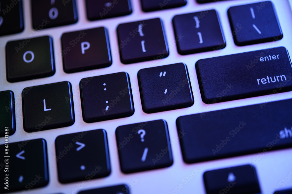 Close-up of Modern Black Keyboard with Glowing Blue Backlight, Focus on Enter Key Close-up of Modern Black Keyboard with Glowing Blue Backlight, Focus on Enter Key
