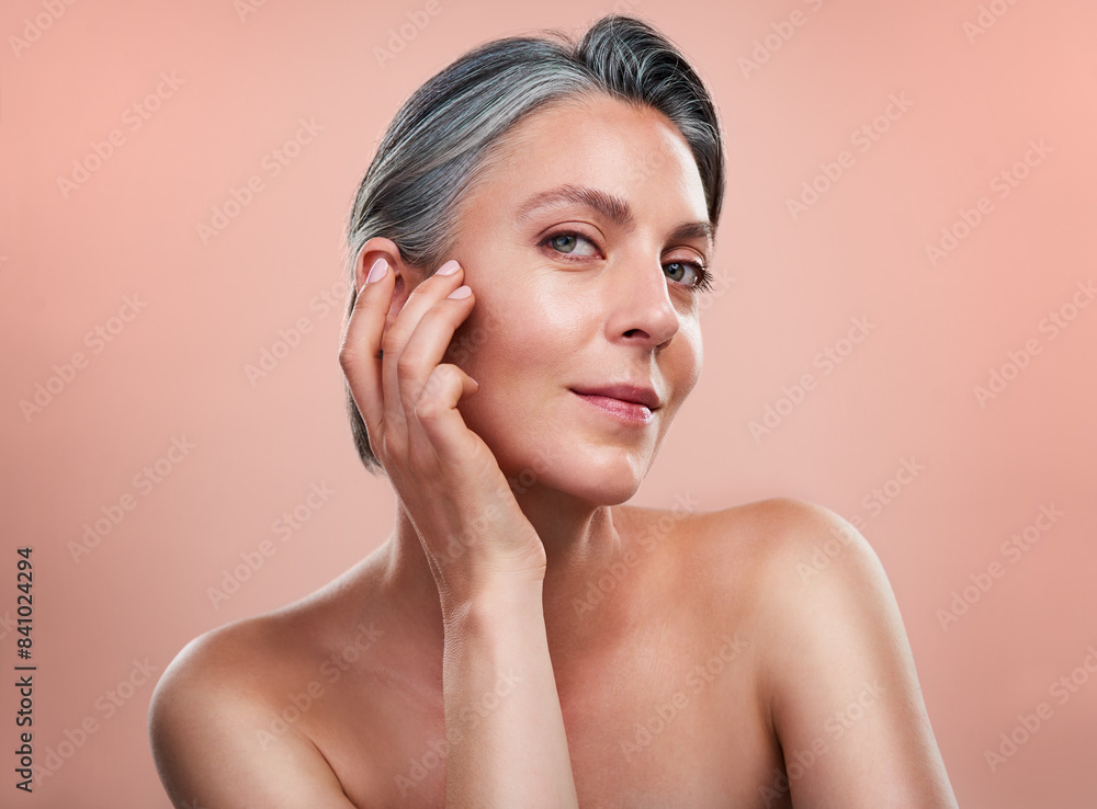 Portrait, skincare and mature woman with anti aging in studio for cosmetology, dermatology or natural glow on pink background. Wellness, hands and model person for facial, spa treatment or cosmetics Portrait, skincare and mature woman with anti aging in studio for cosmetology, dermatology or natural glow on pink background. Wellness, hands and model person for facial, spa treatment or cosmetics
