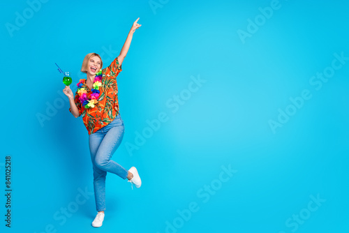 Photo of glad nice cool cute girl wear stylish print clothes have fun weekend look empty space isolated on blue color background