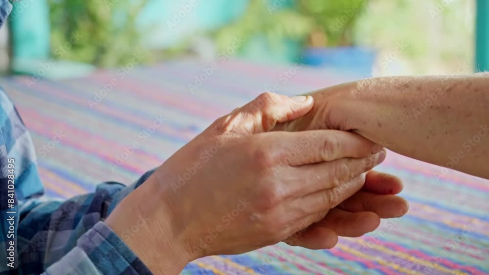 The hands of a male child give love and care to his mother's hands, caressing them with care and love. The hands of a male child give love and care to his mother's hands, caressing them with care and love.