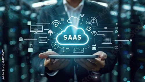 Business concept. Internet and networking technology. SaaS (software as a service). Businessman show virtual screen of SaaS icons for software services on cloud system. Strategic business success 